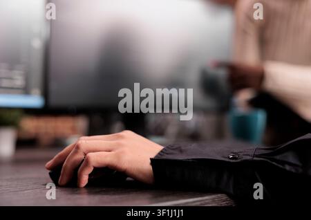 Software developer writes software code at an office desk, using computer screens, algorithms and database tools for digital application development. Stock Photo