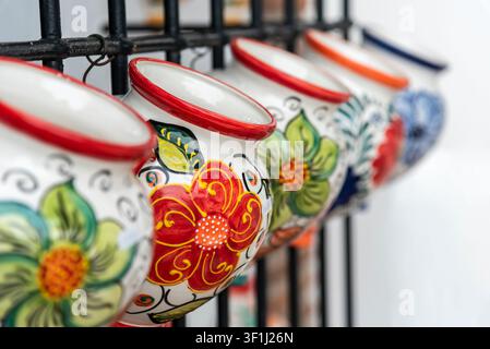 Traditional spanish andalucian wall flower handmade pots hand painter with colorful flowers Stock Photo