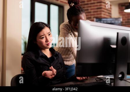 Engineers plan software security workflow while developing cloud computing data, HTML scripts and algorithms on a workplace computer inside an IT office. Stock Photo