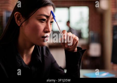 Tired tech programmer brainstorming ideas about coding solution, finding algorithm to create database script, developer feeling pensive and thinking about software developing system in it agency. Stock Photo