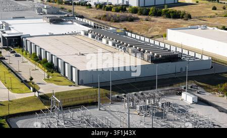 Large data center building processing information with an adjacent power substation Stock Photo