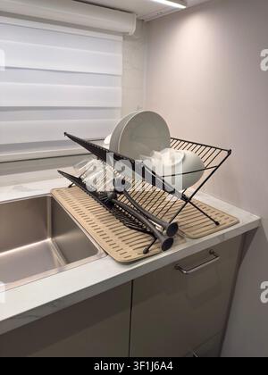 Modern Kitchen Dish Drying Rack with Clean Plates and Glassware Stock Photo