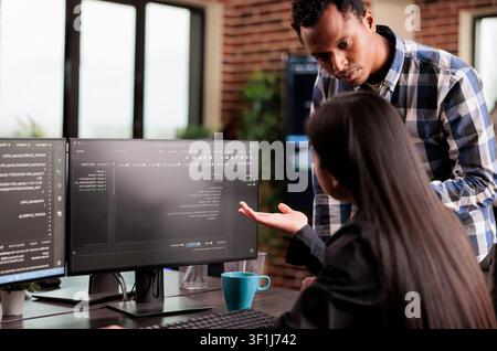 System engineers write binary security code in a development agency, working on programming tasks and protected digital infrastructure. Stock Photo