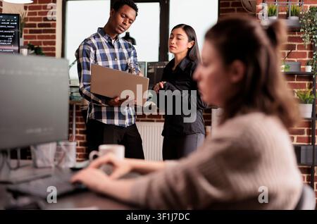 Software developers looking at security firewall on laptop, using html and terminal window, working in it programming office, during a domestic lifestyle moment. Stock Photo