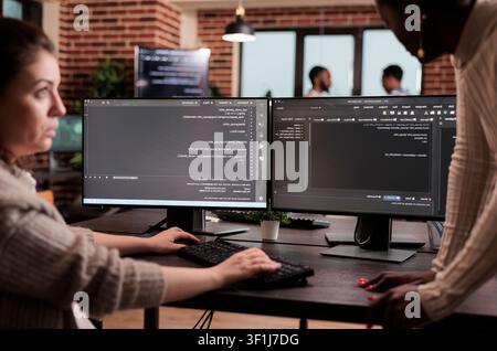 Diverse programming engineers developing html code and cloud computing in it development agency, Software developer working on database programming with html script, computing big data. Stock Photo