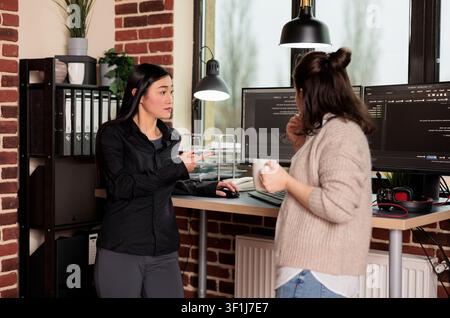 Multi ethnic system engineers developing software algorithm for information processing and network optimization, Software developers programming it application working in company office. Stock Photo