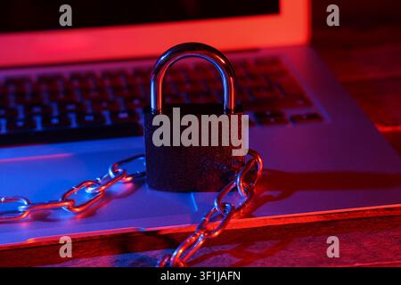 Padlock with chain on laptop, closeup. Cyber security concept Stock Photo