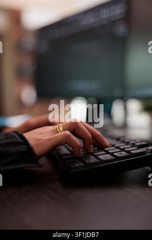 Security application engineer encrypts vital company information on a blockchain system while developing artificial intelligence data processing code. Stock Photo