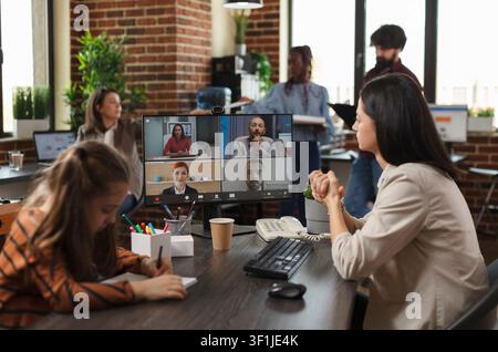 Businesswoman communicates with colleagues on a video conference call while presenting a financial project idea and marketing methods. Stock Photo