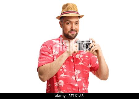 Smiling young male tourist holding a vintage camera isolated on white background Stock Photo