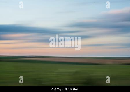 ICM abstract background with motion blur and flowing light in sunset colours of blue and orange, creating a soft texture and dreamy atmosphere. Stock Photo