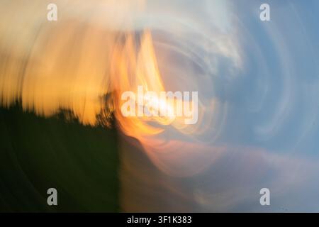 Abstract ICM motion blur with flowing light in sunset colours of blue and orange, creating a soft, dreamy atmospheric background with copy space. Stock Photo