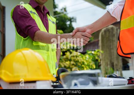 Cropped shot of engineers shaking hands at construction site for building project partnership Stock Photo