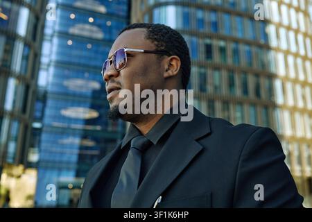 Black Businessman Standing Outside Office for Leadership Branding Stock Photo
