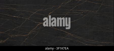 A luxurious black marble stone surface displaying prominent gold and bronze natural veins. Stock Photo