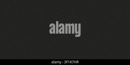 A dark charcoal grey or black surface with dense fine white speckled grains, resembling granite or basalt. Stock Photo