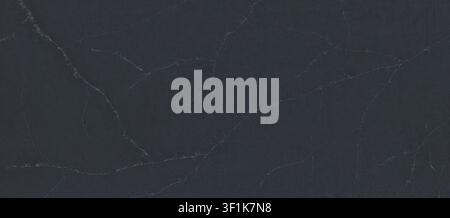 A full-frame view of a dark charcoal quartz slab with fine white veins across the surface. Stock Photo