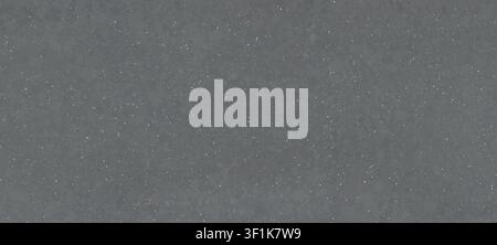 A flat-lay view of a medium grey quartz slab surface with a fine speckled texture. Stock Photo