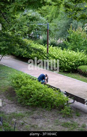 A person sitting alone on a park bench in Wonji Park along Changdeokgung-gil in Seoul. Stock Photo