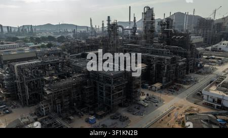 An industrial petrochemical refinery featuring metal piping and fractionation columns at a largescale manufacturing facility in si racha thailand. Stock Photo