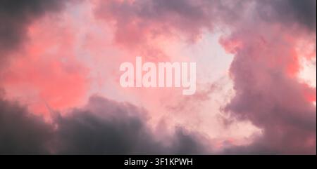 Pink sky with stormy clouds. Sunrise clouds are in vanilla colours. Beauty in nature. Details of evening sunset. Natural abstraction. Tension concept Stock Photo