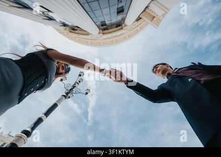 Business handshake between two professionals during an outdoor meeting in front of office building Stock Photo
