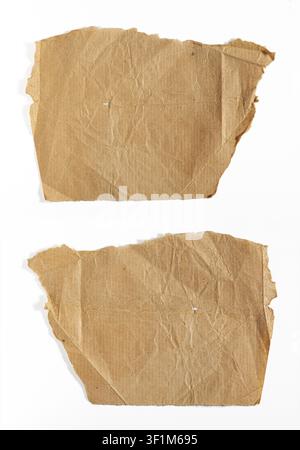 Close up of the front and back of a blank torn brown kraft paper piece isolated on white background. Minimalist vintage crumpled paper scraps mockup. Stock Photo