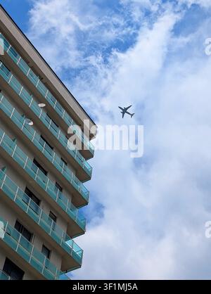 Contemporary residential buildings with blue and orange balconies under a bright blue sky Stock Photo