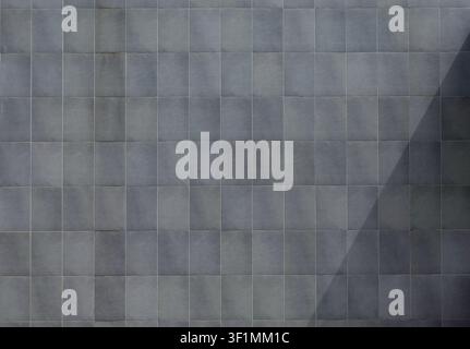 Elegant gray stone tiles on a large exterior wall. Background and texture. Stock Photo