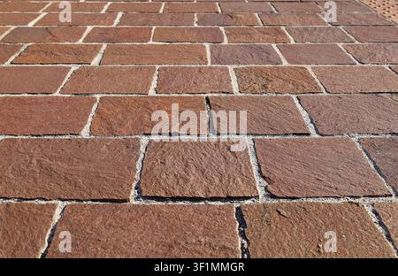 Self-locking anti-slip brown stone tiles for outdoor flooring. Background and texture. Stock Photo