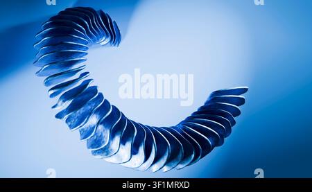 A striking abstract image featuring a twisting geometric shape with deep blue tones set against a soft gradient background, creating a modern and dyna Stock Photo