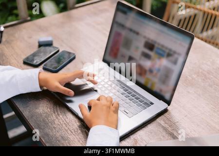 Close up of hands using laptop computer for online work outdoors Stock Photo