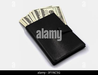 Black leather wallet full of hundred dollar bills on white background Stock Photo
