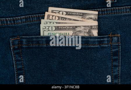 US dollar banknotes inside blue jeans back pocket Stock Photo