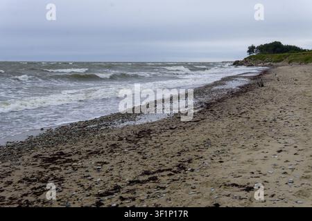 Rough waves on a deserted Baltic Sea beach near the Northern Forts in Liepaja, Latvia, during windy and overcast weather. Stock Photo