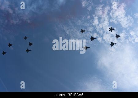 Paris, France - 07 14 2026: Air show of July 14. 12 Rafale Military planes flying above the district of La Defense Stock Photo