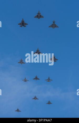 Paris, France - 07 14 2026: Air show of July 14. 12 Rafale Military planes flying above the district of La Defense Stock Photo