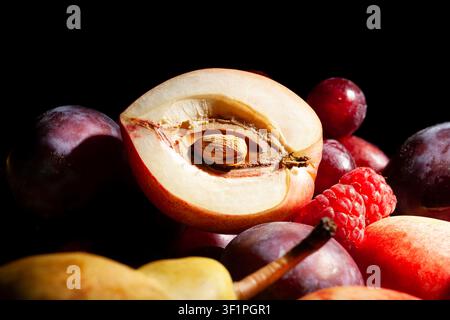 sliced white nectarine fruit mix on black background Stock Photo
