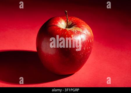red apple on red background Stock Photo