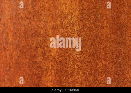 Rusted metal sheet texture background, close up of weathered orange rust spots and corrosion runs on metallic surface, detailed full frame oxidized Stock Photo