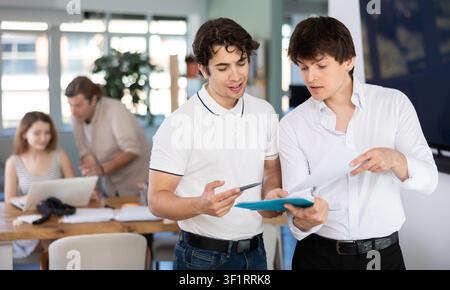 Two bank managers discuss documents in modern office Stock Photo
