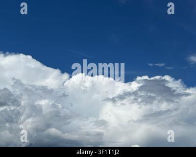 Blue sky filled with dramatic cumulus clouds Stock Photo