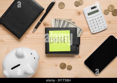 Budget planning with wallet, money, piggy bank, and calculator on a wooden desk, top view Stock Photo