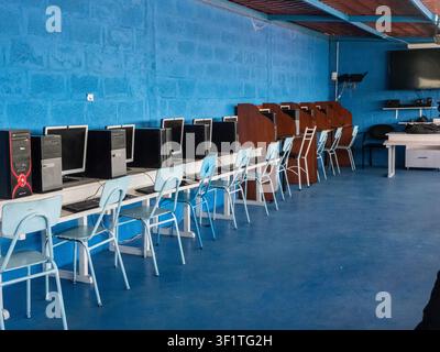 Empty computer laboratory equipped with desktop computers, monitors, keyboards, and student workstations in an educational institution. The classroom Stock Photo