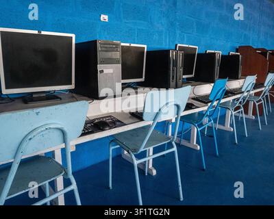 Empty computer laboratory equipped with desktop computers, monitors, keyboards, and student workstations in an educational institution. The classroom Stock Photo