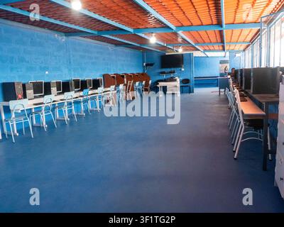 Empty computer laboratory equipped with desktop computers, monitors, keyboards, and student workstations in an educational institution. The classroom Stock Photo