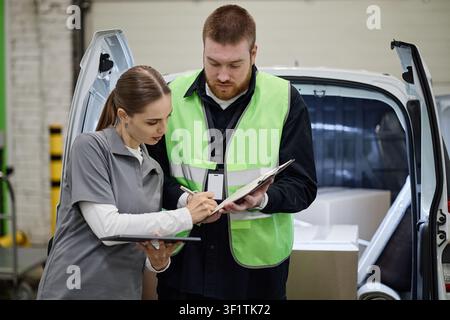 Adult Delivery Workers Checking Inventory for Individual Storage Stock Photo