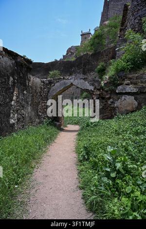 Winding Heritage Path Between Ancient Fortress Walls Leading to Historic Stone Archs Stock Photo