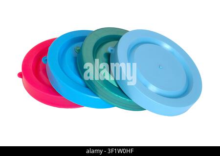 Colorful plastic lids arranged in a row. Round container covers for food storage. Kitchen accessory for sealing jars and bowls. Stock Photo