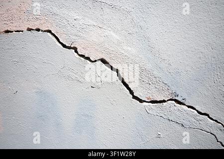 Crack seen in a concrete wall in a building interior Stock Photo